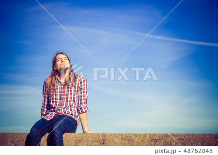 Man long hair relaxing outdoor sky background Man long hair relaxing outdoor sky background 48762848