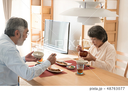朝食を食べる日本人シニア夫婦　真顔 48763077