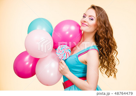 Woman with colorful balloons and lollipop 48764479