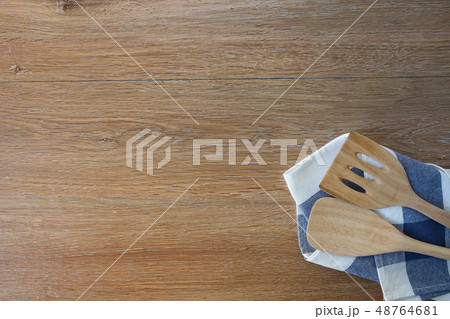 Wooden kitchen utensils and linen kitchen towels  48764681