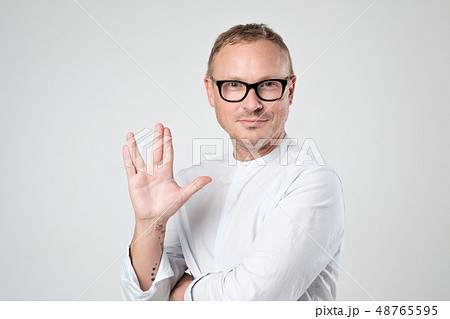Vulcan greeting. Man welcomes fans of fiction film 48765595