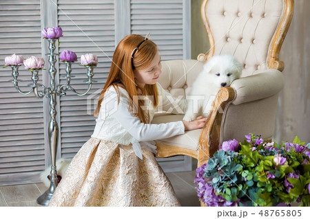 Portrait of ginger hair girl play with husky poppy Portrait of ginger hair girl play with husky poppy 48765805