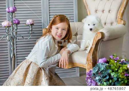 Portrait of ginger hair girl play with husky poppy Portrait of ginger hair girl play with husky poppy 48765807