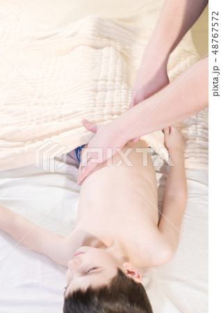 A little boy at the reception at a professional masseuse. Male manual worker gives massage to the 48767572