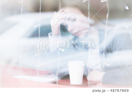 Portrait of an attractive young female journalist holding on to her head worried or in a headache in Portrait of an attractive young female journalist holding on to her head worried or in a headache in 48767669