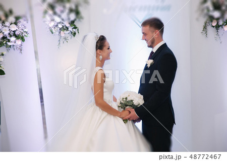 Happy newlyweds in restaurant. Groom and bride in their wedding day 48772467