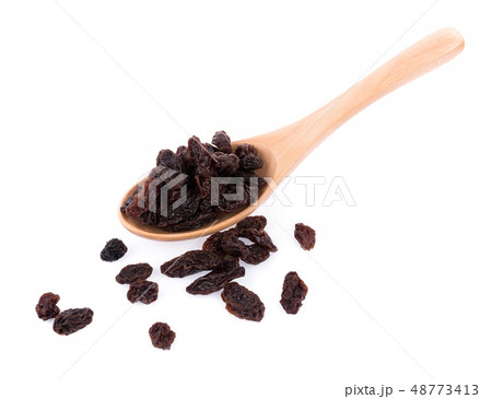 Dried raisins in spoon on white background Dried raisins in spoon on white background 48773413