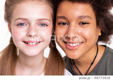 Peaceful appealing kids connecting faces while photographing Peaceful appealing kids connecting faces while photographing 48773816