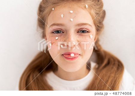 Childish good-looking girl showing her tongue while lying Childish good-looking girl showing her tongue while lying 48774008