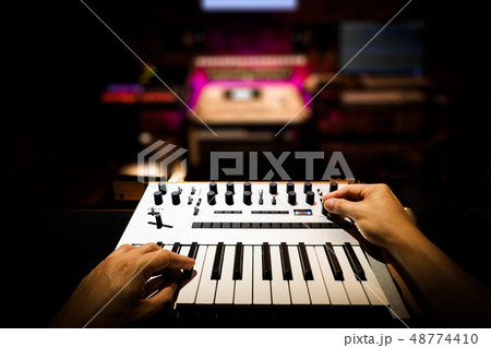 musician hands playing keyboard in home studio 48774410