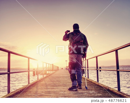 Man is just keeping memories with camera phone in 48776621