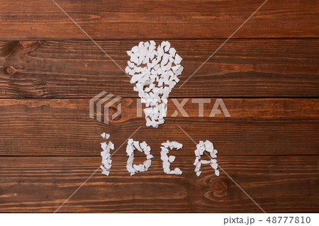 Pieces of paper on the table in the shape of lamp. Pieces of paper on the table in the shape of lamp. 48777810