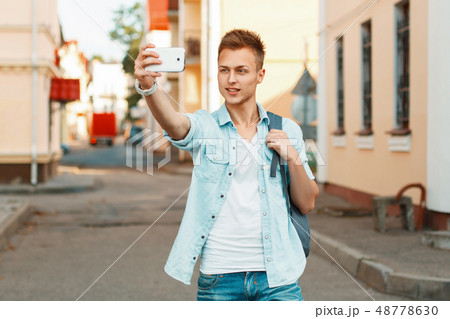 Modern touristYoung boy near a wooden wall Modern touristYoung boy near a wooden wall 48778630
