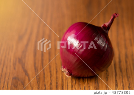 Fresh purple onion on dark wooden background. 48778803