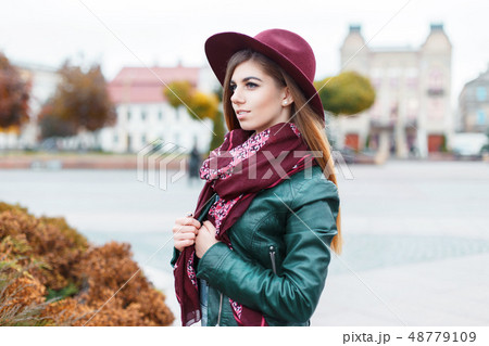 Beautiful fashionable woman in a hat Beautiful fashionable woman in a hat 48779109