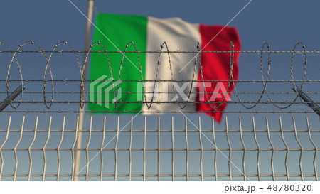 Defocused waving flag of Italy behind barbed wire fence. 3D rendering 48780320