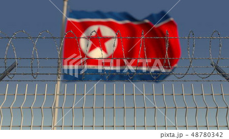 Barbed wire against waving flag of North Korea. 3D rendering Barbed wire against waving flag of North Korea. 3D rendering 48780342