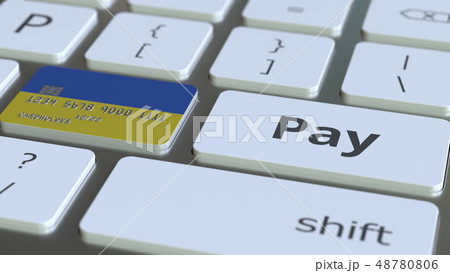 Bank card featuring flag of Ukraine as a key on a computer keyboard. Ukrainian online payment Bank card featuring flag of Ukraine as a key on a computer keyboard. Ukrainian online payment 48780806