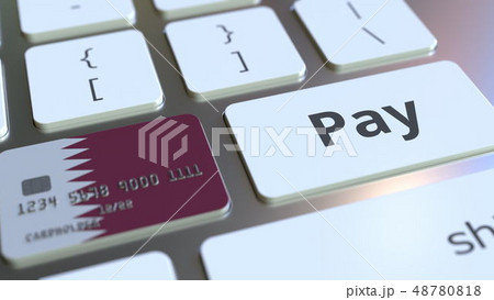 Bank card featuring flag of Qatar as a key on a computer keyboard. Qatari online payment conceptual Bank card featuring flag of Qatar as a key on a computer keyboard. Qatari online payment conceptual 48780818