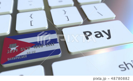 Bank card featuring flag of Cuba as a key on a computer keyboard. Cuban online payment conceptual 3D 48780882