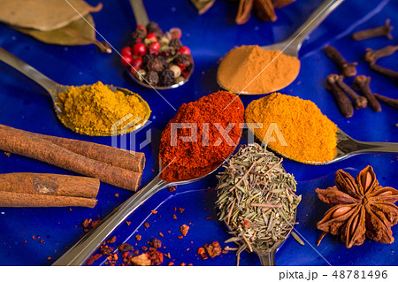Different colorful spices on dark blue background Different colorful spices on dark blue background 48781496