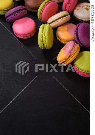 Assorted colorful macaroons on a dark background Assorted colorful macaroons on a dark background 48781928