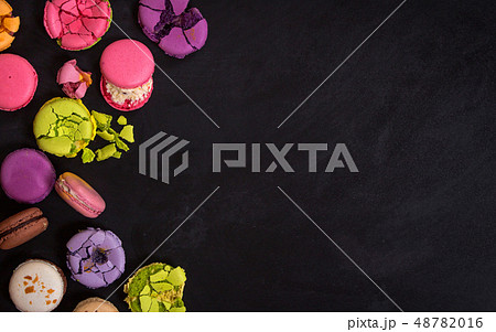 Assorted colorful macaroons on a dark background Assorted colorful macaroons on a dark background 48782016