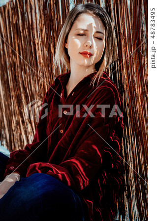 Sad woman sitting near window and shadows Sad woman sitting near window and shadows 48783495