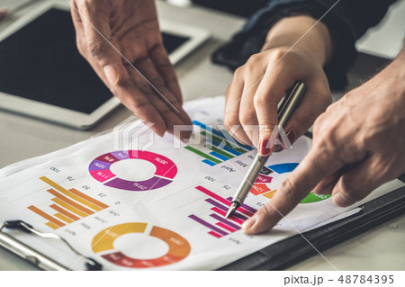 Business people working with business report. Business people working with business report. 48784395