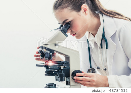 Doctor using microscope in hospital laboratory. 48784532