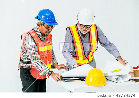 Senior engineer and architect working with drawing Senior engineer and architect working with drawing 48784574