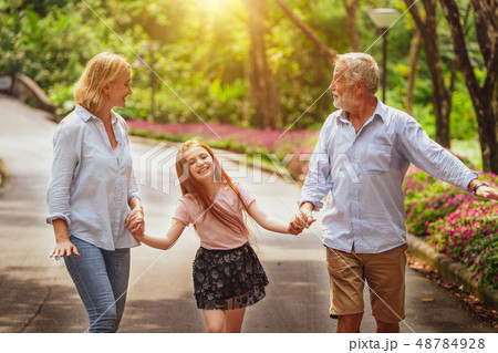 Happy healthy family walk together in the park. 48784928