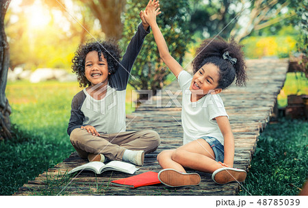 Happy little boy and girl in the park. Happy little boy and girl in the park. 48785039