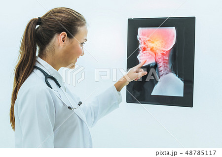 Doctor working with x ray film of patient head. 48785117