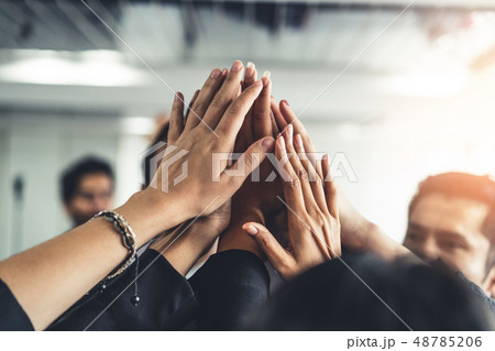 Many happy business people raise hands together. Many happy business people raise hands together. 48785206