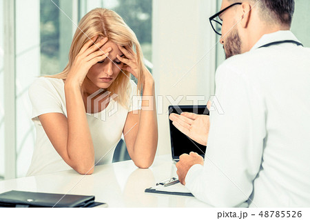 Male Doctor and Female Patient in Hospital Office Male Doctor and Female Patient in Hospital Office 48785526
