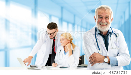 Doctor working in hospital with other doctors. Doctor working in hospital with other doctors. 48785735
