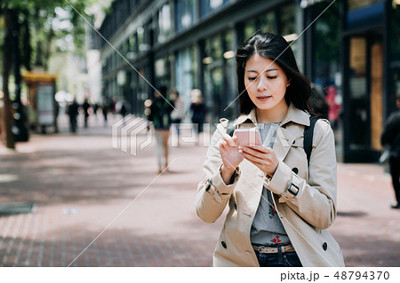 office lady using mobile phone replying email office lady using mobile phone replying email 48794370