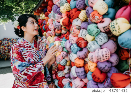 woman in kimono hanging on colorful wish ball 48794452
