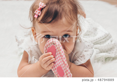 Newborn baby and a pair of baby shoes 48794889