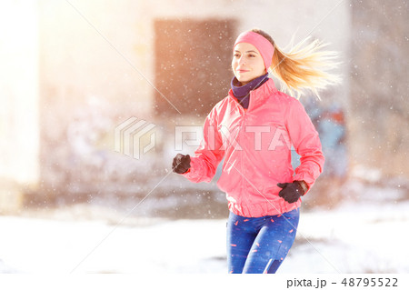 Young slim woman jogging in winter park Young slim woman jogging in winter park 48795522