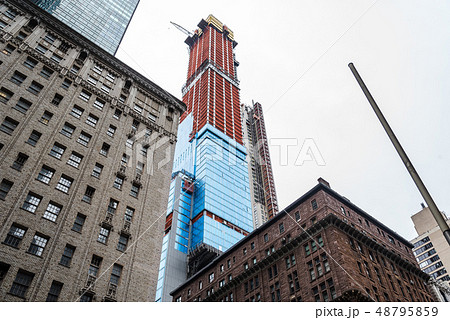 Low angle view of buildings and skyscraper under construction Low angle view of buildings and skyscraper under construction 48795859