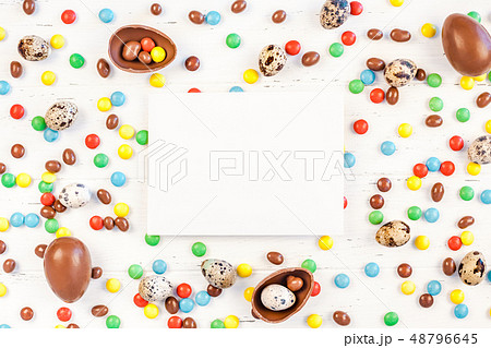 Easter frame with chocolate eggs, colorful candies Easter frame with chocolate eggs, colorful candies 48796645