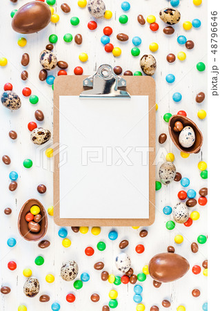 Easter frame with chocolate eggs, colorful candies Easter frame with chocolate eggs, colorful candies 48796646