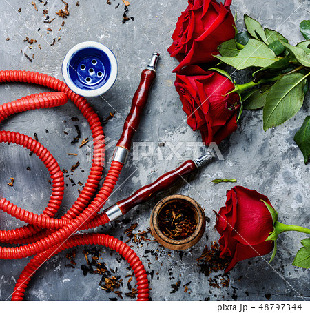 Smoking hookah with rose flavor Smoking hookah with rose flavor 48797344