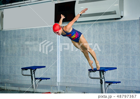 Female athlete jumps to the pool water. Female athlete jumps to the pool water. 48797367