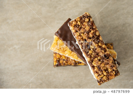 Various muesli bars on marble stone background 48797699