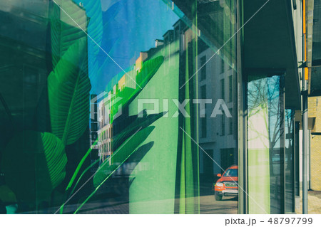 The reflection of the city buildings in the window 48797799