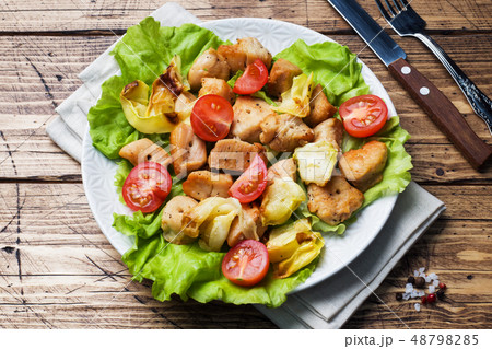 Stewed pieces of chicken with vegetables  48798285