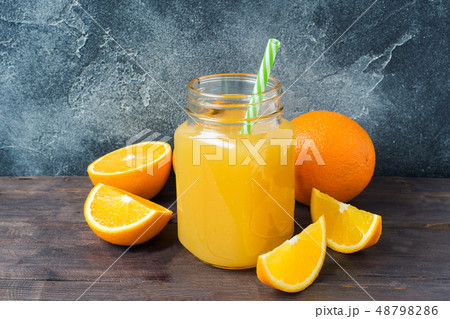 Orange juice in glass jar and fresh fruits oranges Orange juice in glass jar and fresh fruits oranges 48798286